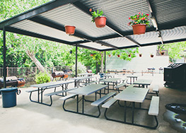 Covered Patio overlooking the Comal River with community BBQ pit.